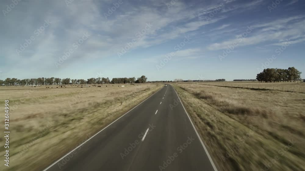 A Countryside Route in Argentina as seen from a Double-decker Bus on Road. A Countryside Route in Argentina as seen from a Double-decker Bus on Road.
