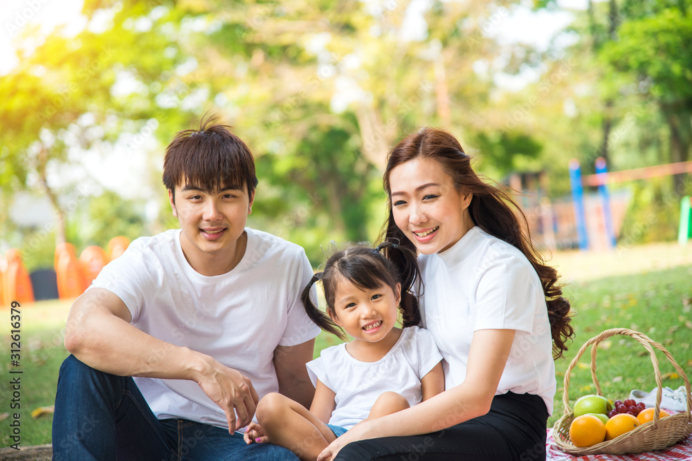 Portrait Of Happy Asian Family In Garden Portrait Of Happy Asian Family In Garden