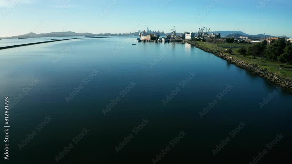 Fast pass over the beach and marina shore line on a sunny afternoon sun down.