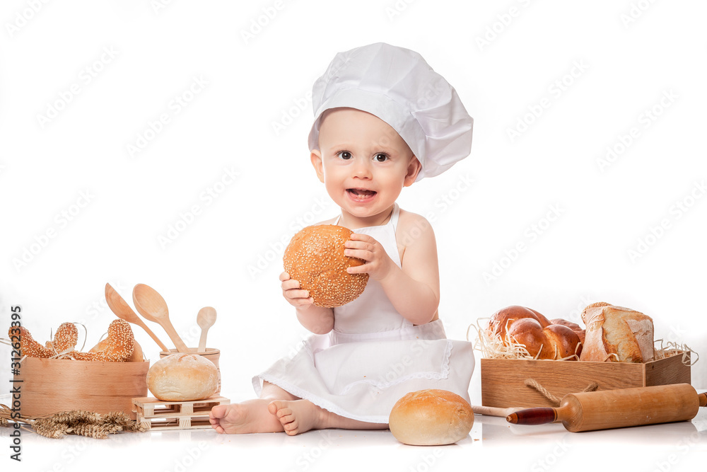 baby cook sits on the table bread bread flour. isolated on white. big size resolution. Food banner for text or design. Cooking child lifestyle concept baby cook sits on the table bread bread flour. isolated on white. big size resolution. Food banner for text or design. Cooking child lifestyle concept