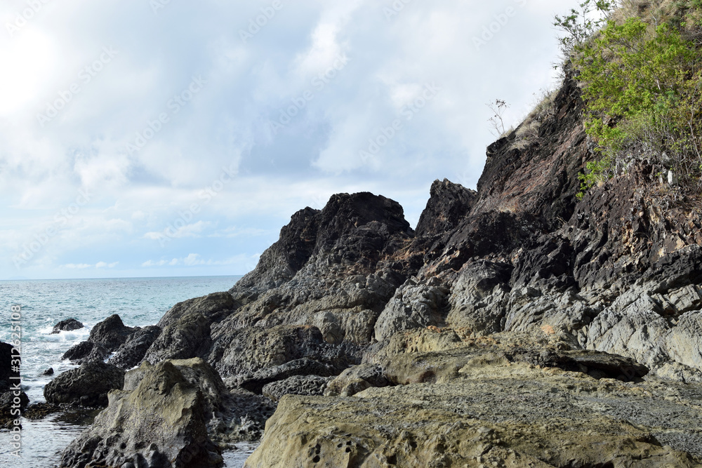 seawaves pounding tropical island rocks in outlying shores of Hugom, San Juan, Batangas, Philippines