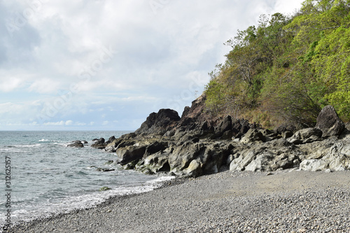 seawaves pounding tropical island rocks in outlying shores of Hugom, San Juan, Batangas, Philippines photo