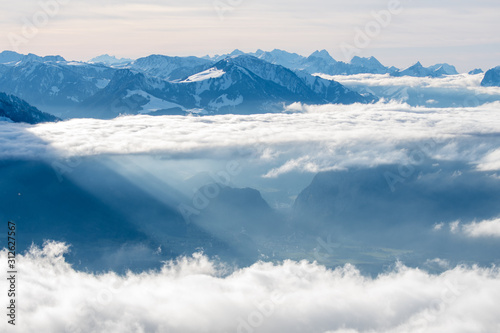 sea of clouds with sunrays at the side of Mount Niesen and Simmental