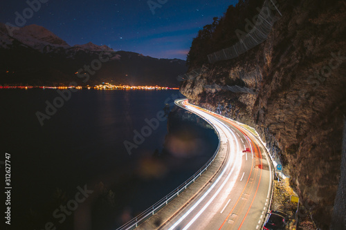 lighttrails of a s-curved street along Lake Thun during the Blue hour