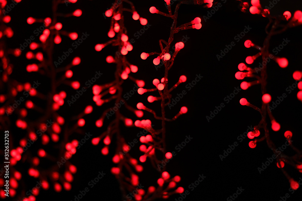wallpaper patterned with round shaped red lights bokeh on black background