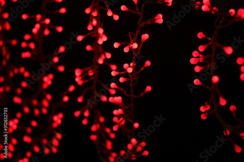 wallpaper patterned with round shaped red lights bokeh on black background