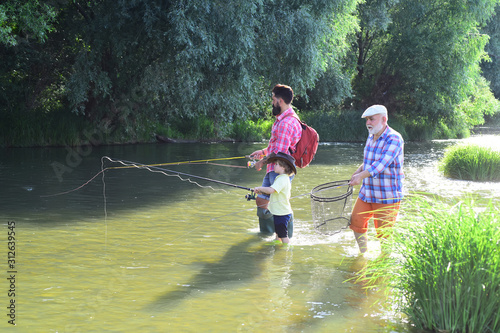 Happy people family have fishing and fun together. Men hobby. Man in different ages. Outdoors active lifestyle. Father and son fishing. photo