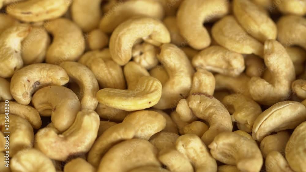 Walnut close up. product rich in minerals and vitamins. Cashew turns in a shot. Cashew kernels rotating. Cashew close up lies under beams of the sun. Macro 4K Walnut close up. product rich in minerals and vitamins. Cashew turns in a shot. Cashew kernels rotating. Cashew close up lies under beams of the sun. Macro 4K