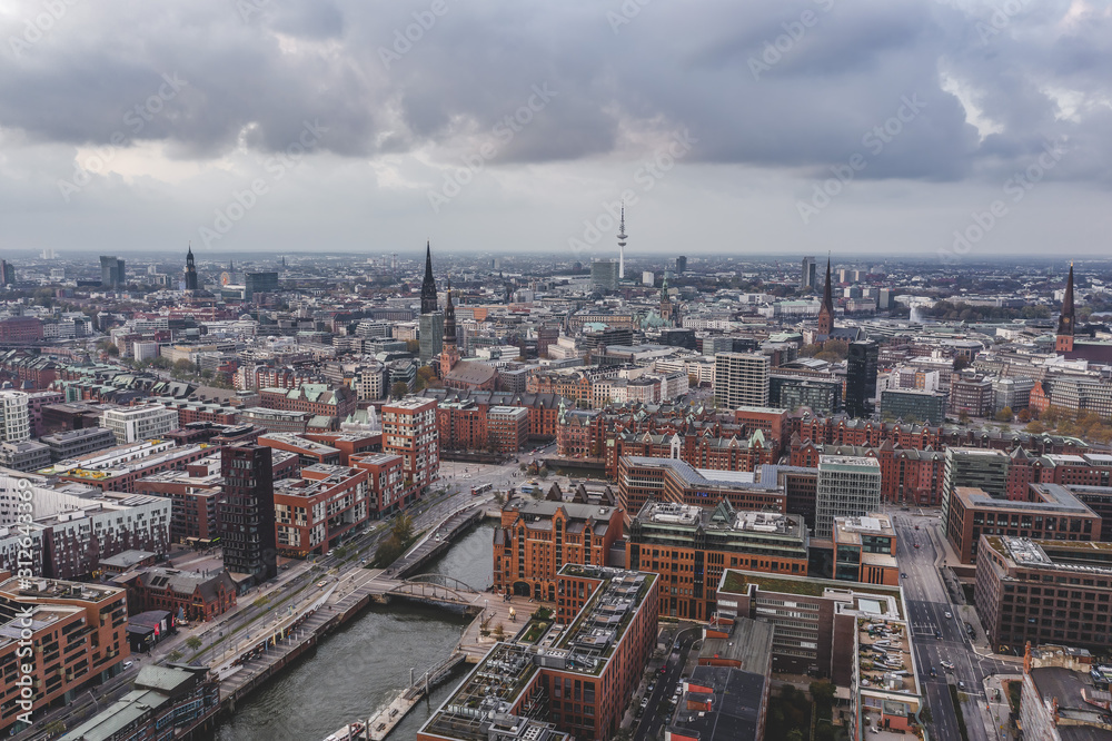 Aerial drone view of Port of Hamburg with clouds over historical city center and sea port