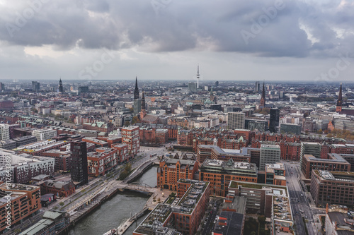 Aerial drone view of Port of Hamburg with clouds over historical city center and sea port © Davidzfr