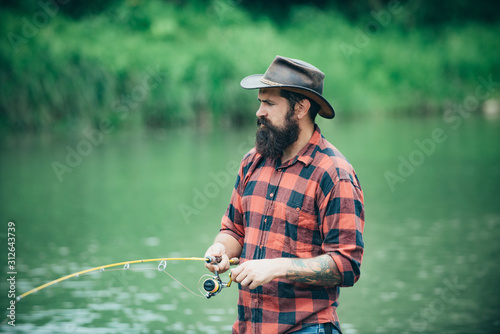 Male hobby. Man at riverside enjoy peaceful idyllic landscape while fishing. Difference between fly fishing and regular fishing. Man dressed in shirts on the lake. Fish normally caught in wild.
