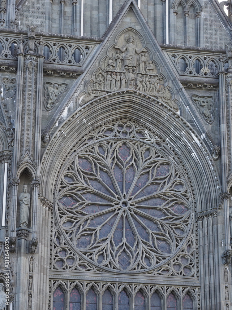 Detail of west front portal with rose window of cathedral in european Trondheim city, Norway - vertical