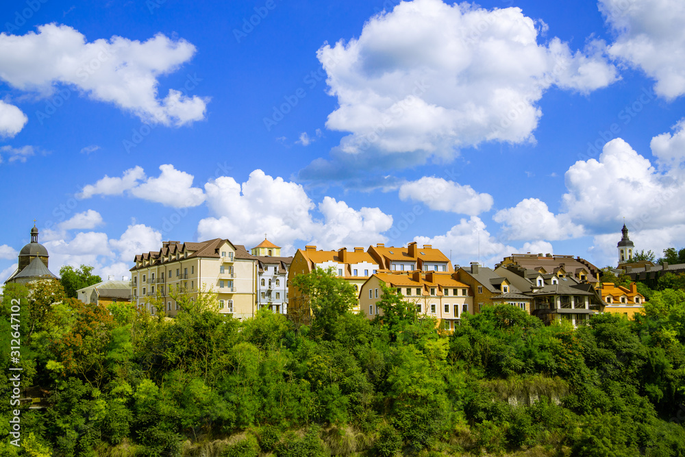 green city living apartments ecology concept district in Europe urban landmark picture with buildings above trees foliage summer time blue sky white clouds background empty copy space for your text