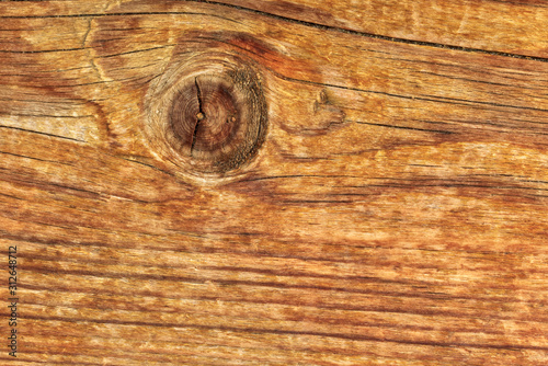 Pine wood texture. Flat old vintage pine board surface with knots and curving layers. Top view, Orange color tone.