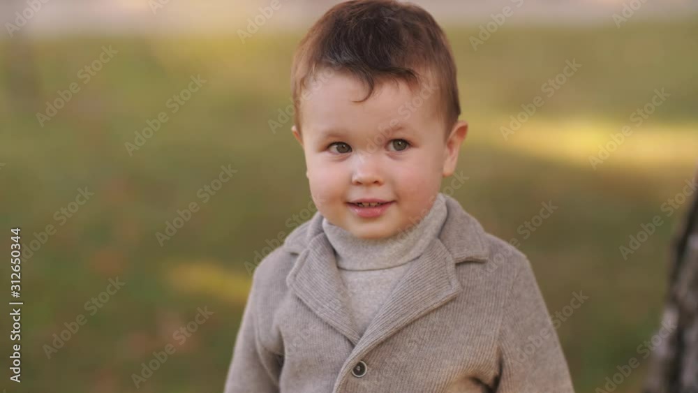 Cute boy in autumn park Cute boy in autumn park