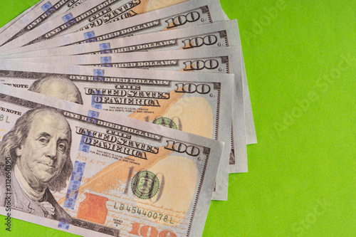 US Dollar bills against green background photo