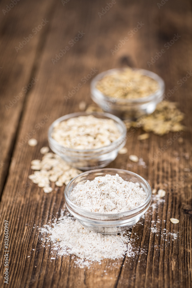 Old wooden table with fresh Oat Flour (close-up shot; selective focus) Old wooden table with fresh Oat Flour (close-up shot; selective focus)