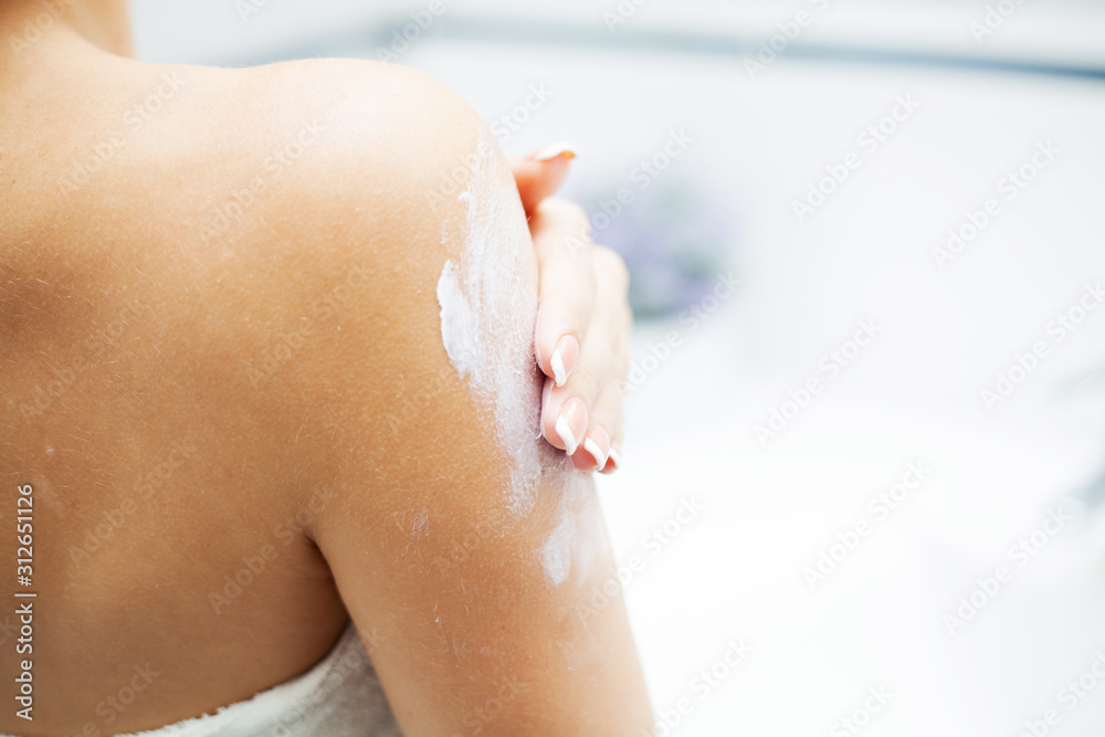 Close up hands use care products in light bathroom Close up hands use care products in light bathroom