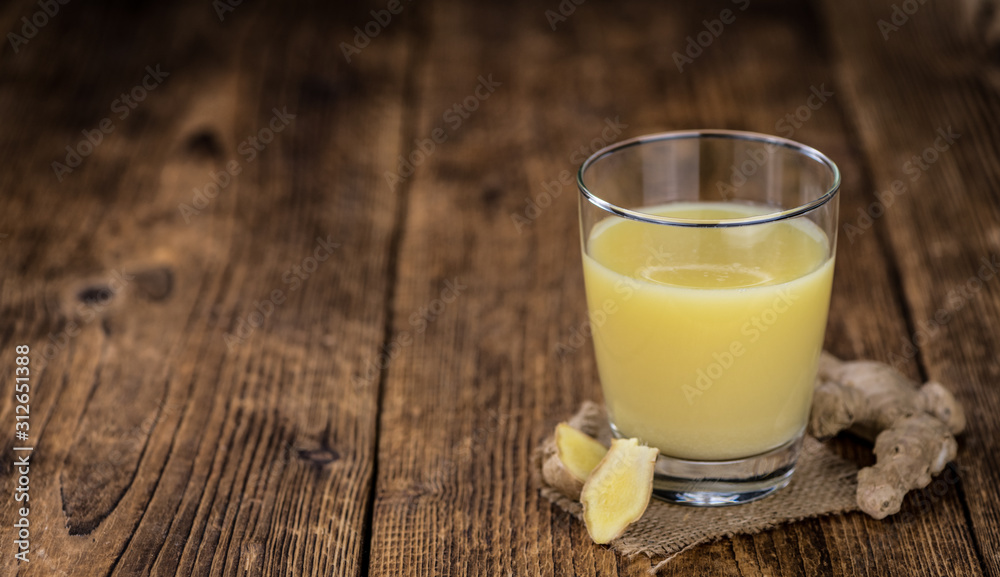 Some fresh Ginger Drink (selective focus; close-up shot)