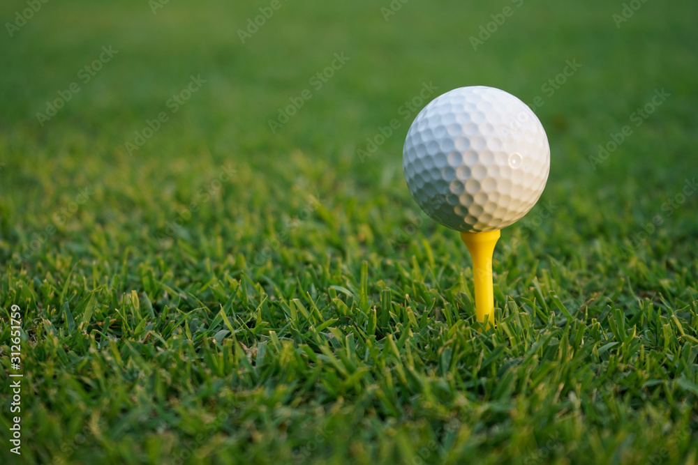 Golf ball on tee in beautiful golf course at sunset background. Golf ball on tee in beautiful golf course at sunset background.