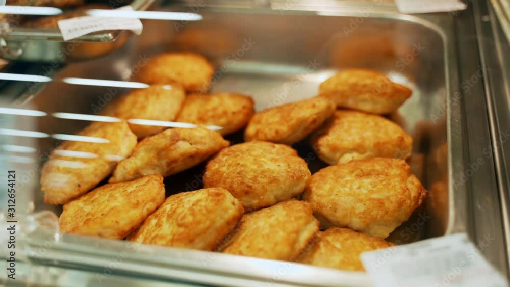 A variety of assortments in the supermarket: baked cutlets in the oven.