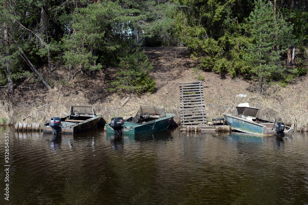Motor boats near the shore Tornincasa channel. Vologda region Motor boats near the shore Tornincasa channel. Vologda region