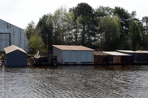 Garages for boats on the shore Tornincasa channel. Vologda region