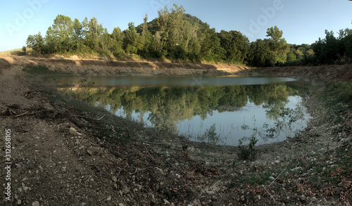 Freshly-dug fishing lake in Montespertoli, region of Florence in Tuscany photo