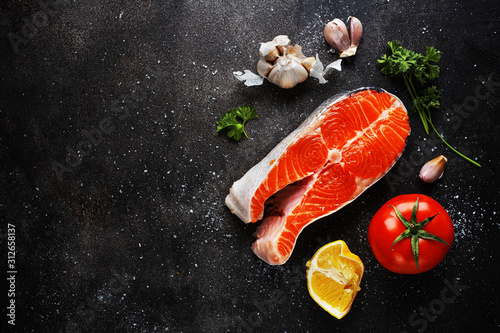 Raw fish steaks with ingredients