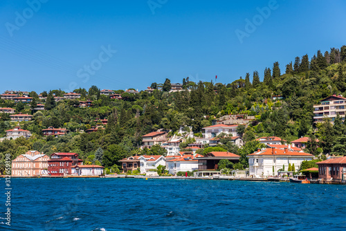 Beautiful builings and mansions at the costline and hillslope with green forest in summer, at Bosphorus Strait in Istanbul,Turkey. View from a Cruise Ship. © zz3701