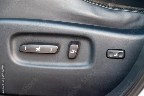 Close-up Interior view with electric seat adjustment, buttons of luxury very expensive new Black car stands after cleaning and detailing in the vehicle repair workshop. Auto service industry