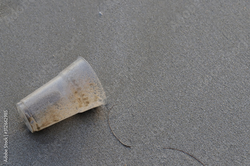 Plastic glass on the beach,garbage on the beach