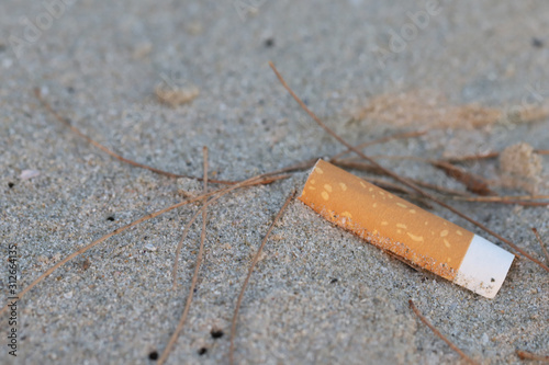Cigarette butt on the beach,garbage on the beach