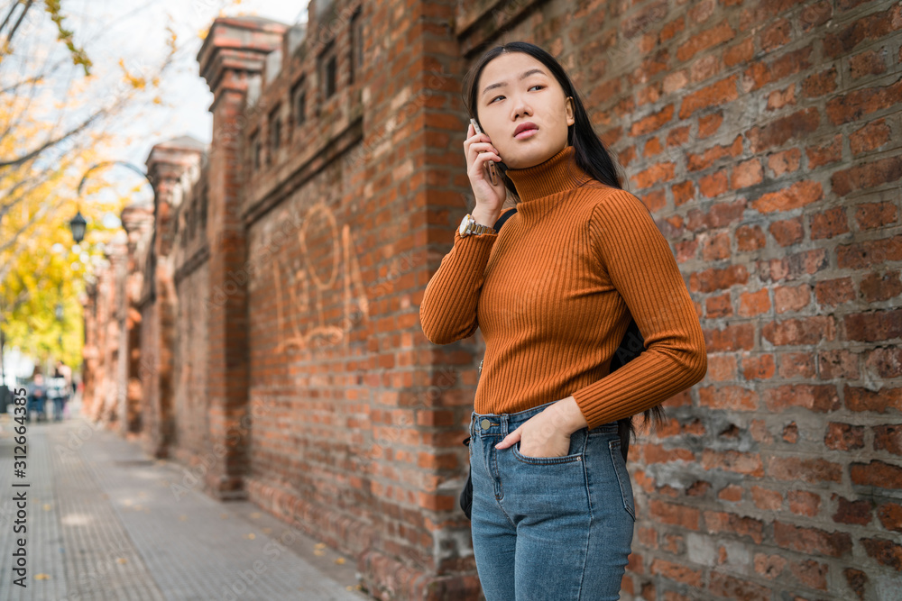 Asian woman talking on the phone.