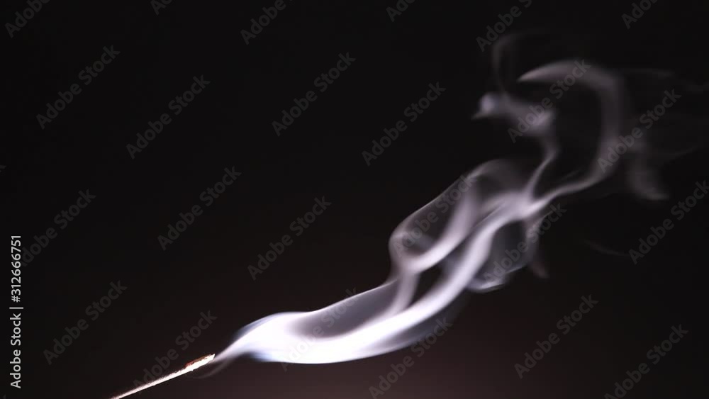 The wisps of smoke from the incense stick slowly rise up and curl with bizarre curls in rare tremors of air. The wisps of smoke from the incense stick slowly rise up and curl with bizarre curls in rare tremors of air.