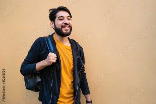Beared man with backpack on his shoulders.