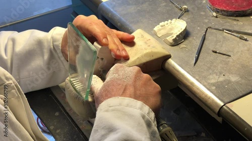 Dental technician working on brackets