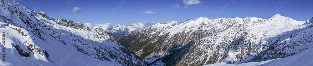 The snowy mountains, the nature and the landscape of the Valtellina after the first snowfall of the season in the Alps, near the town of Tartano, Italy - November 2019. The snowy mountains, the nature and the landscape of the Valtellina after the first snowfall of the season in the Alps, near the town of Tartano, Italy - November 2019.