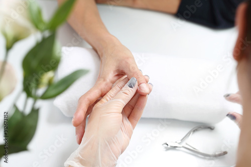 Cutting cuticles  manicure. Woman at the beauty salon