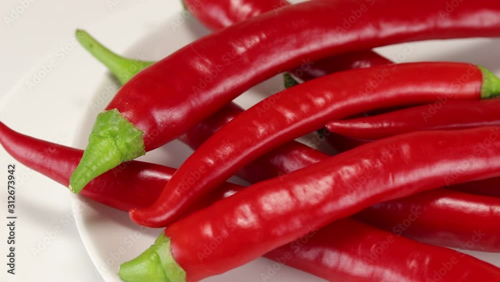 The camera moves along a pile of hot pepper, side view from above, close-up The camera moves along a pile of hot pepper, side view from above, close-up