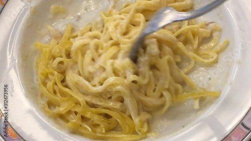 Eating fettuccine pasta