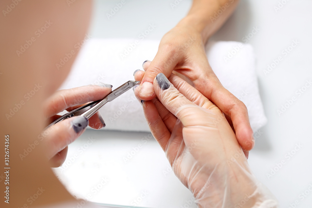 Cutting cuticles, manicure. Woman at the beauty salon Cutting cuticles, manicure. Woman at the beauty salon