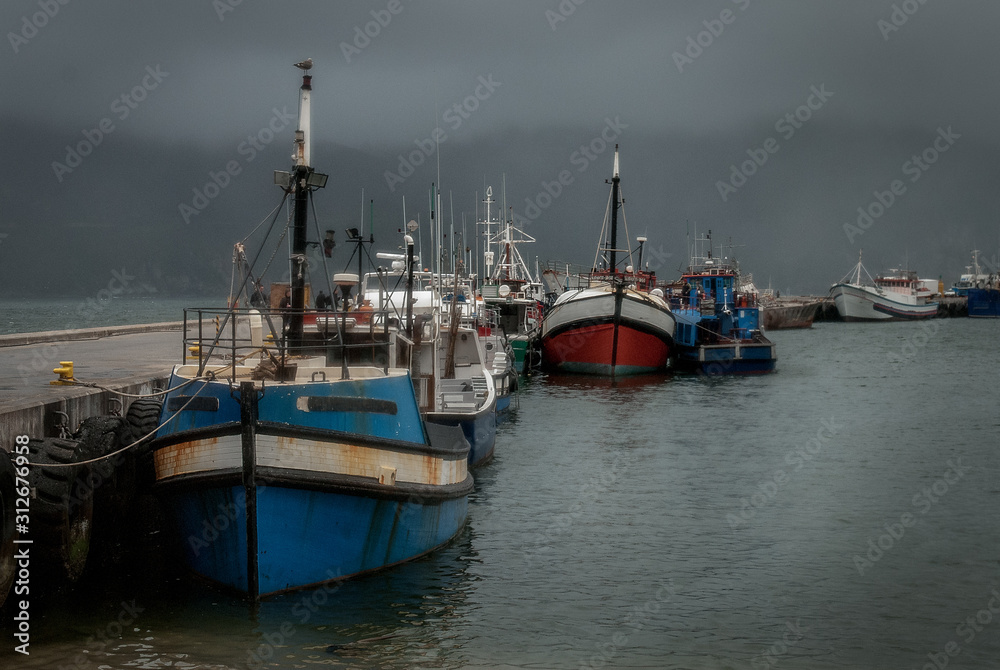 Wet and windswept fishing fleet in port