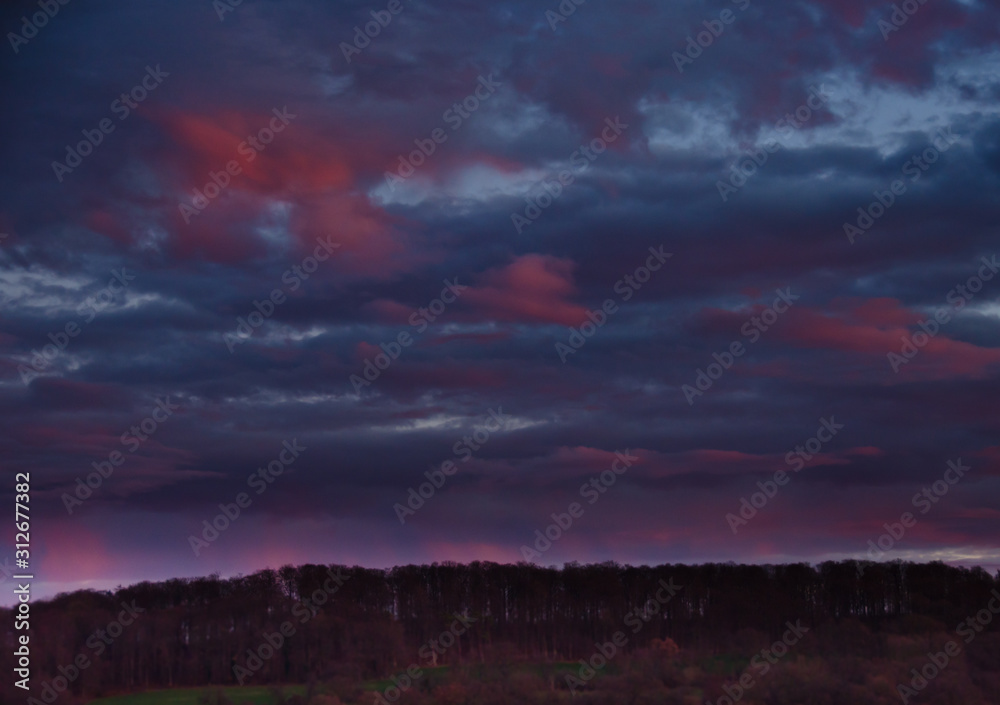 A very extraordinary and beautiful sunset in orange and purple colours, lightened and bright A very extraordinary and beautiful sunset in orange and purple colours, lightened and bright