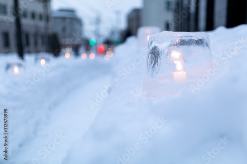 Ice lantern with candle burning inside