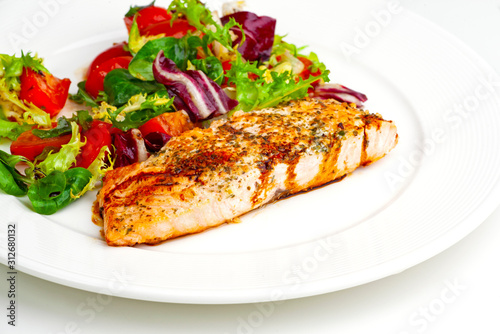 grilled salmon steak with vegetables and sauce