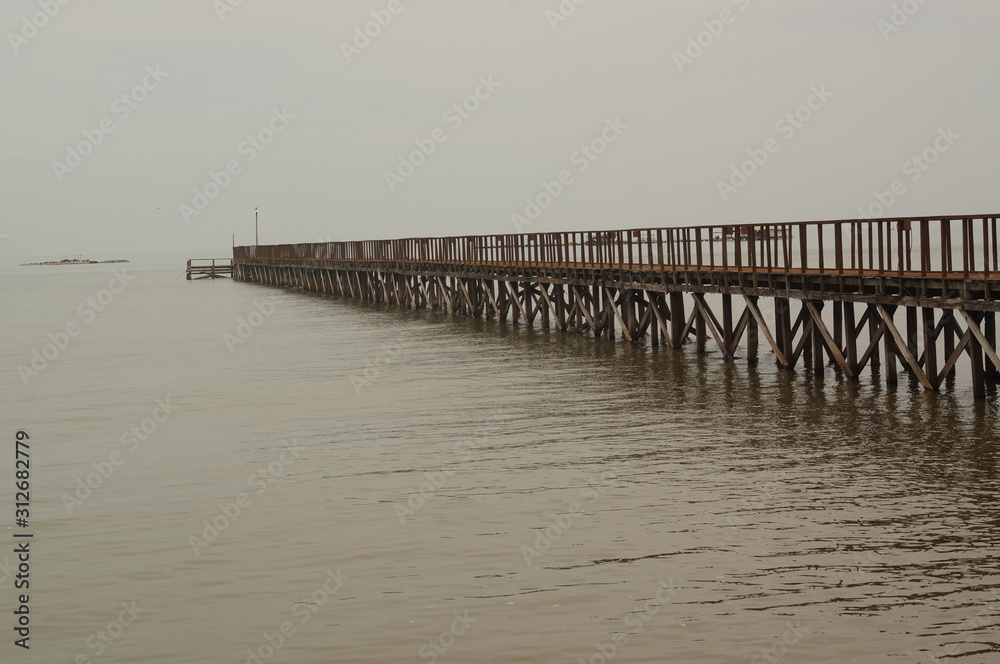 The wooden pier is used for leaning on traditional fishing boats