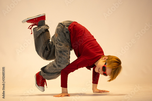 young dancer in breakdance position, child in a unique dance pose