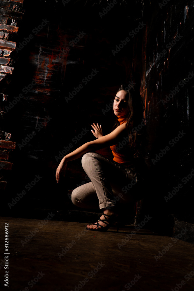 Beautiful model are seating in the dark room Beautiful model are seating in the dark room