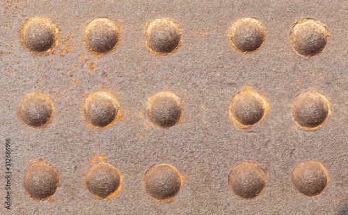 Old Weathered Rusty Metal Wall With Riveted Joints photo